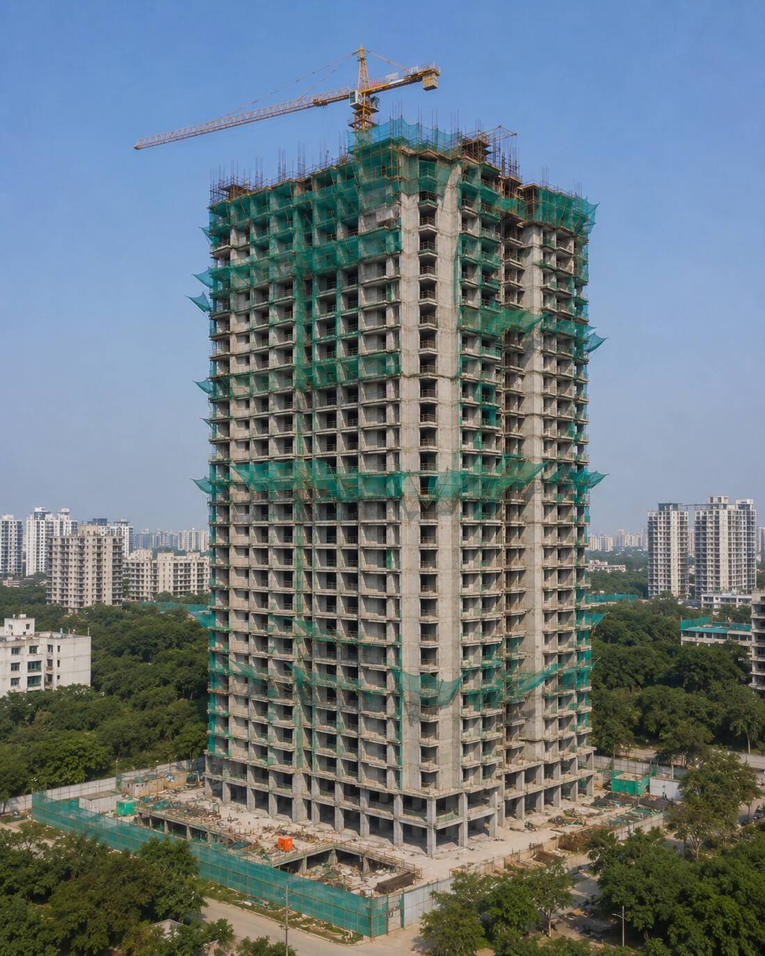Tower under construction with crane and safety netting