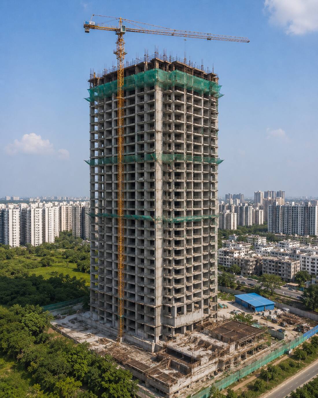 High-rise residential tower fully wrapped in green safety netting