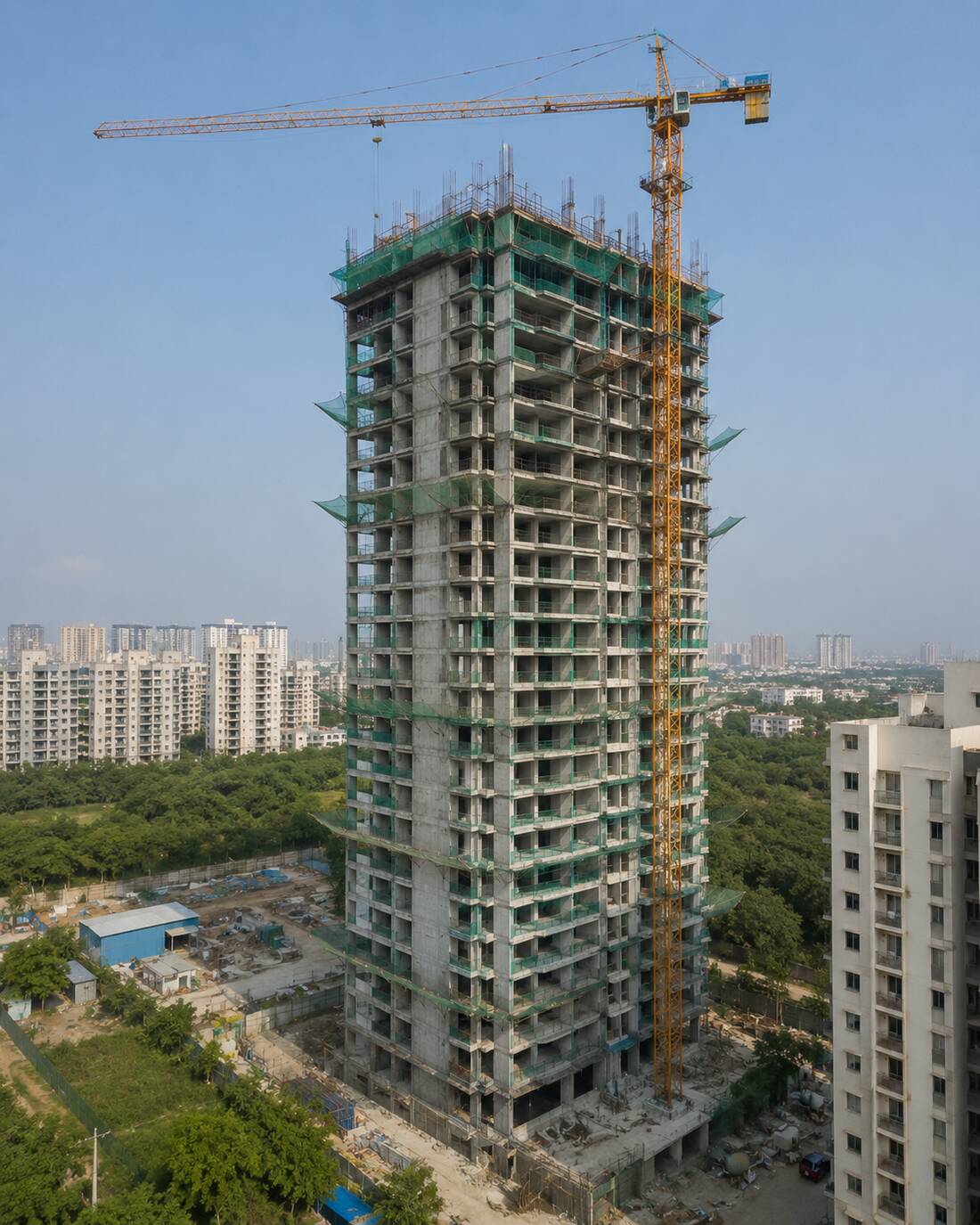 Three residential towers under construction with edge netting